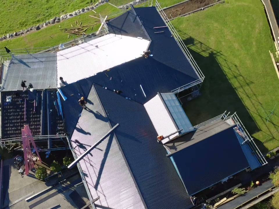 Overhead view of a re-roof with underlay down on one section and new sheets on the next