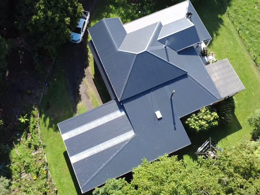 Finished dark longrun roof on a Taranaki home, photographed from the air