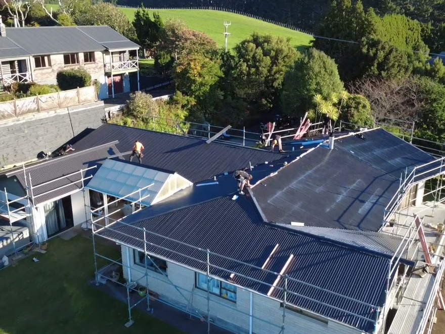 Taranaki house under scaffold with the new dark roof going on